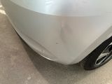 a close up of a car ' s front bumper with a denting on it