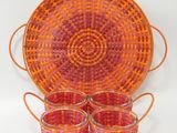 panier orange et rose contenant quatre tasses et un plateau muni de poignées