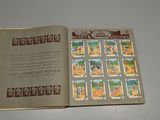 an open book with stamps on it sitting on a table