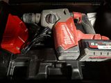 a tool in a toolbox with a cord and a hammer