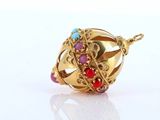 an image of a close up of a gold ring with a red and blue bead