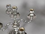 a silver candelab with four candles on it