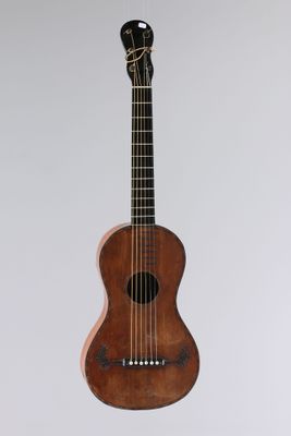 a small wooden guitar hanging from the ceiling