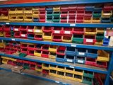 a large rack with many different colored bins in a warehouse