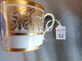 a gold and white cup with a price tag on it