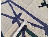 the rug is made of wool and has a blue and white design