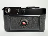 the camera is black and has a red and white logo on it