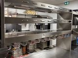 a large kitchen with stainless steel counter tops and stainless steel appliances