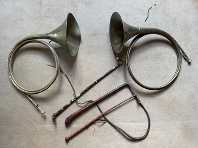 two horns, a horn, and a pair of scissors on a table