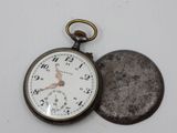 a pocket watch sitting next to a coin on a table