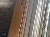 several pieces of wood are stacked up in a storage area