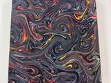 a close up of a painting on a white surface with a black background