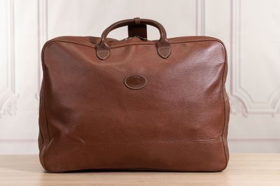 a brown leather briefcase sitting on top of a wooden table