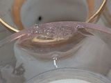 a candle that is sitting on a table next to a bowl