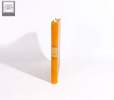 a yellow book that is sitting on a white surface