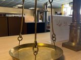 a gold scale sitting on top of a wooden table