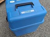 a blue box that is sitting on the ground