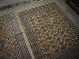 two rugs on the floor next to each other