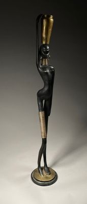 an image of a statue of a woman with a hat on her head