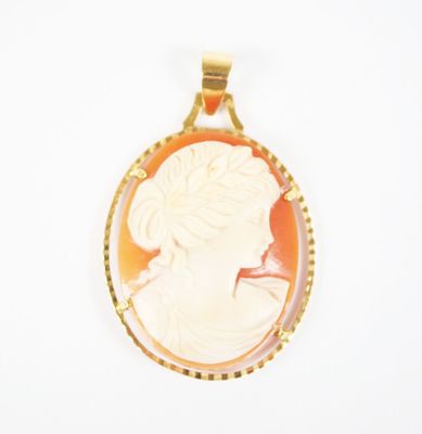 an image of a woman ' s profile is shown in a gold plated pendant