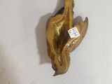 gold plated figurine of a bird with a tag on it ' s neck