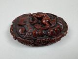 an image of a small carved box with a dragon on it