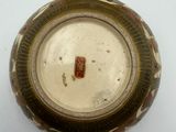 a close up of a brown and white bowl on a white surface