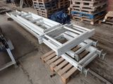 a pile of pallets sitting on the ground next to a pile of wood
