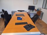 a desk with a laptop, keyboard, mouse, and monitor on it