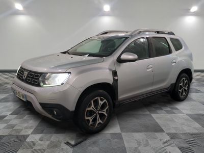 a grey dacia parked in a room with a checkered floor