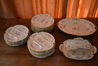 many plates and bowls sitting on a wooden table