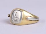 an image of a gold and silver signet ring with an egyptian symbol