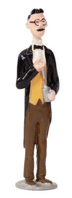 a figurine of a man in a tuxedo holding a glass