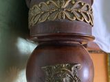 a close up of a wooden pole with a clock on it