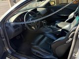 l'intérieur d'une voiture, la portière ouverte et le siège conducteur installé sur la place passager