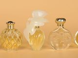 three bottles of perfume sitting next to each other on a table