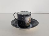 black and white cup and saucer with a picture of a horse on it