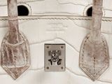 an image of a white handbag with two handles
