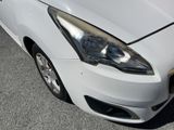 a white car that is parked on the side of the road