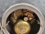 a close up of a clock that is on a table