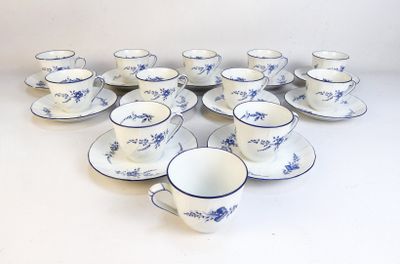 a lot of cups and saucers sitting on a table