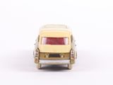a yellow toy car that is sitting on a white surface