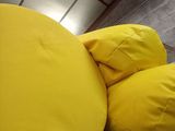 two yellow pillows on top of each other on a bunk bed