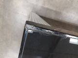 a broken television sitting on a table in a room