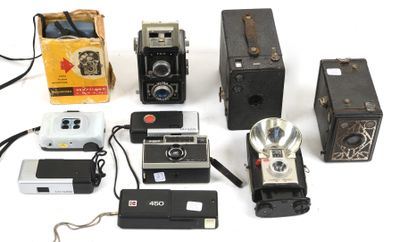 a lot of old cameras and other items on the table