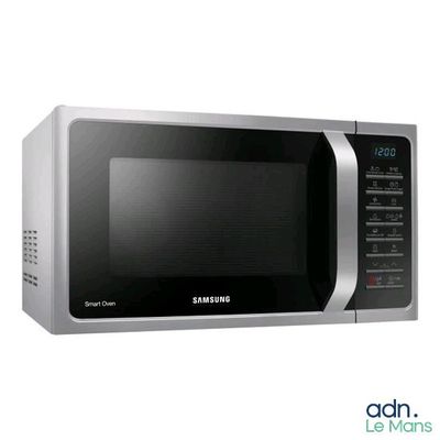 a silver microwave oven with a digital clock on it