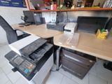 a computer desk with a printer and a printer on it