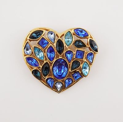 a close up of a heart shaped brooch with blue and green stones