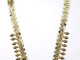 a gold necklace on a white background
