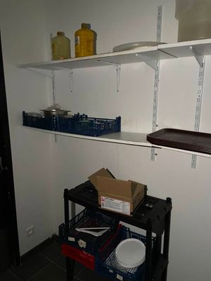 a black cart with boxes on it in a room